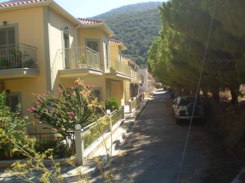 a street in a town with houses and a car at Evangelia in Ayia Evfimia