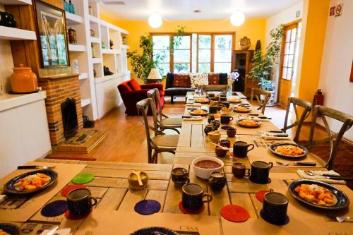 a long table with food on it in a living room at Casa Jacinta Guest House in Mexico City