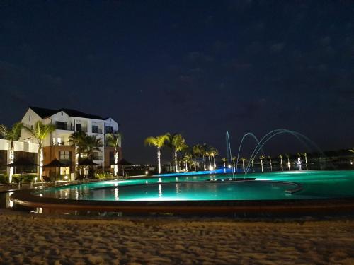 a swimming pool on the beach at night at The Blyde Riverwalk Estate in Pretoria