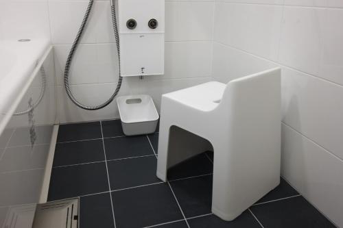 a white bathroom with a sink and a shower at HOTEL FORZA HAKATAEKI CHIKUSHI-GUCHI Ⅰ in Fukuoka