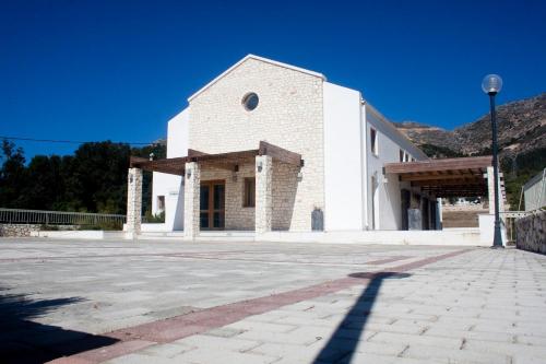a large white church with a clear blue sky at Evangelia in Ayia Evfimia
