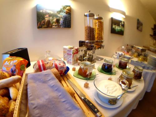 a table with food and other food items on it at Penzion Quest in Loket