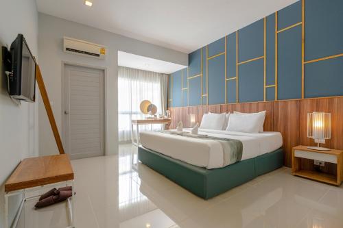 Ένα ή περισσότερα κρεβάτια σε δωμάτιο στο Hug Nimman Hotel