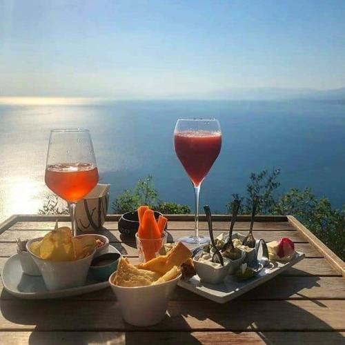 a table with a plate of food and a glass of wine at Villa Crawford in Sant'Agnello