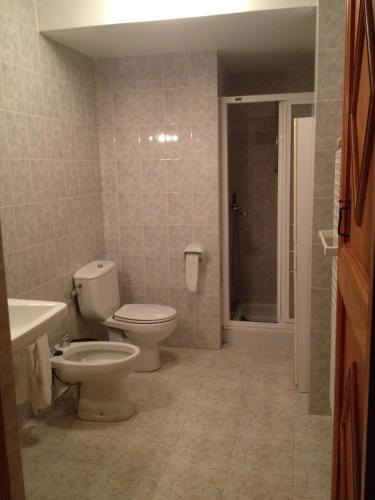a bathroom with a toilet and a sink and a shower at Mas Vell in Catí