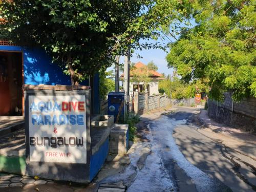 a street with a sign on the side of a road at Aqua Dive Paradise in Tulamben