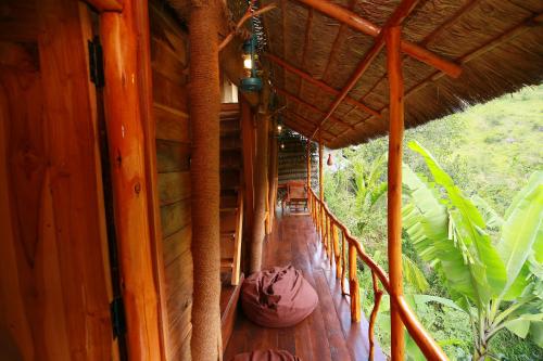 a porch of a house with a wooden floor at Mount Wood Star in Ella