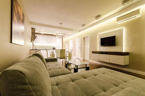 a living room filled with furniture and a tv at Old Town Luxury Apartment in Krakow