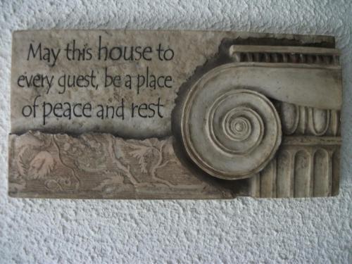 a stone plaque with a picture of a camera on a wall at Clare Street B&B in Nenagh