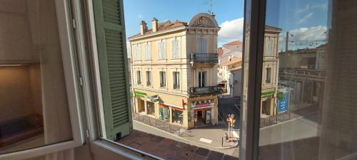 a view of a city from an open window at 123 Sadi Carnot, classé 2 étoiles in Saint-Raphaël