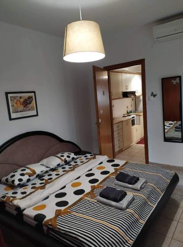 a bedroom with a bed with a cow patterned blanket at Nice and cosy house 2 in Larisa