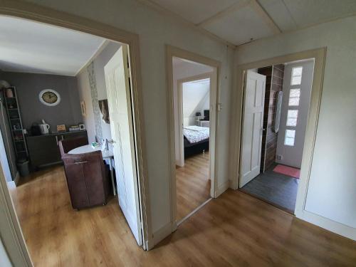 an empty room with a hallway with a bed and a mirror at B&B MaasLandje in Wijk en Aalburg