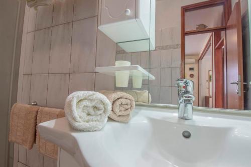 a bathroom with a white sink and a mirror at Apartments Konta Vodice in Vodice