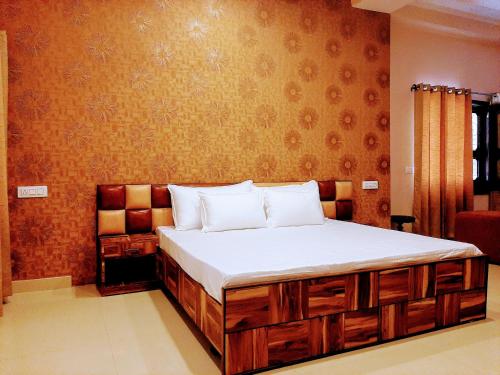 a bedroom with a large bed with white sheets at PANCHHI'S NEST Villa in Amritsar