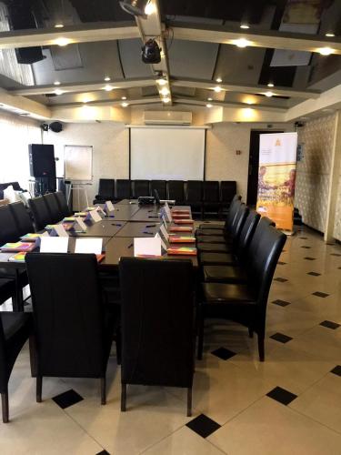 a conference room with a large table and chairs at Kamelot in Ternopilʼ