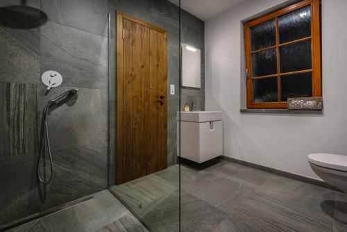 a bathroom with a shower and a toilet at Vila Zvonica - 3 minúty od Starý Smokovec in Nová Lesná