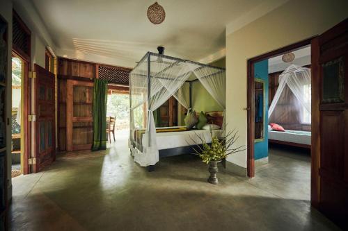 a bedroom with a bed with a canopy at Casa Vana Hiriketiya in Hiriketiya