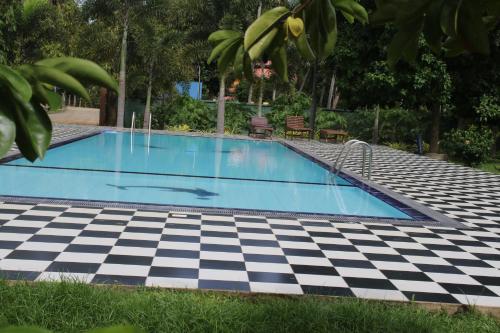 a pool with a black and white checkered floor at The Grand Yala Hotel in Tissamaharama