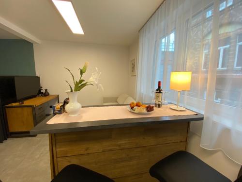 a kitchen with a table with a bowl of fruit on it at City Apartments Hannover in Hannover