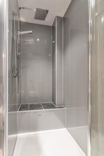 a shower with a glass door in a bathroom at Murrayfield Spacious 2-bedroom apartment in Edinburgh