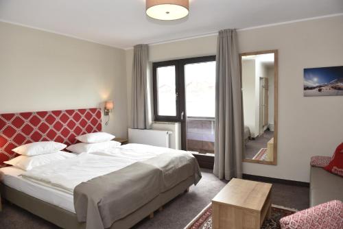 Postel nebo postele na pokoji v ubytování Hotel-Skischule Krallinger