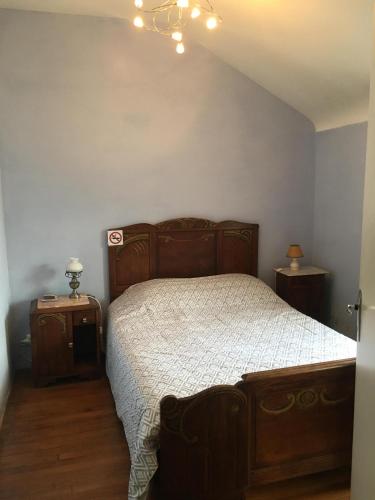 a bedroom with a bed and two night stands at Chez Jojo in Monein