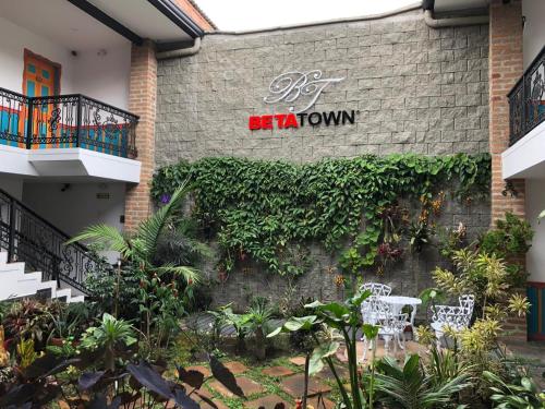a brick building with a sign that reads be a town at Beta Hotel in Salento