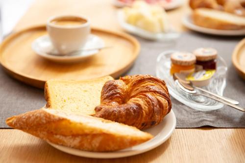 a plate of bread and croissants and a cup of coffee at DWO Ábaster in Soria