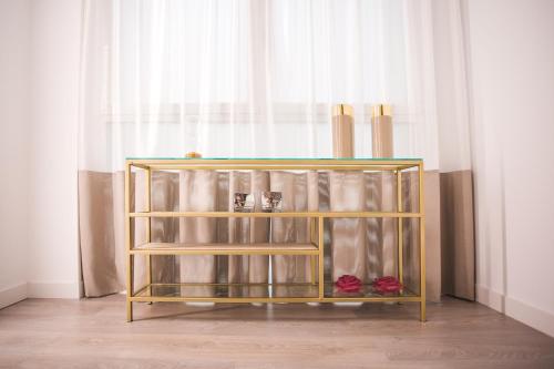 a glass shelf with shoes on it in front of a window at DWO Ábaster in Soria