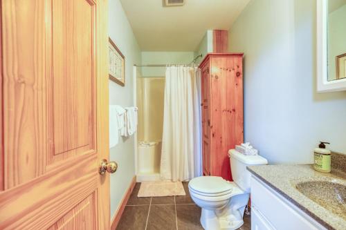 a bathroom with a toilet and a sink and a shower at Cappy's Retreat in Stockton Springs