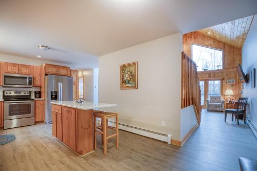 a kitchen with wooden cabinets and a kitchen island at Cappy's Retreat in Stockton Springs