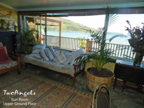 a couch in a living room with a view of the ocean at TwoAngels in Knysna