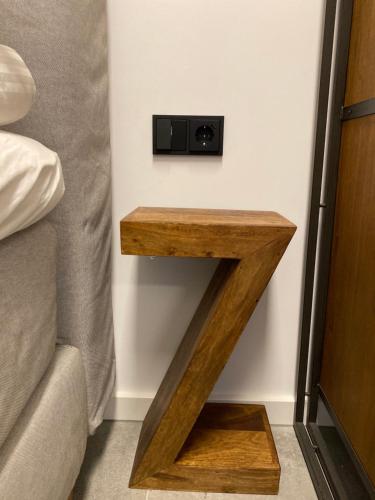 a shelf in the corner of a room next to a bed at City Apartments Hannover in Hannover