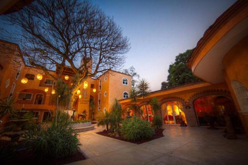 a building with a courtyard with plants in front of it at El Chante Spa Hotel in Jocotepec