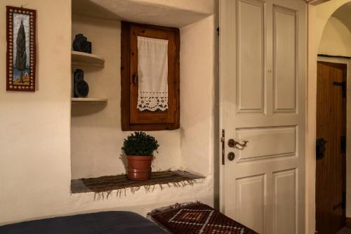 a room with a door and a potted plant at Kanto's Guesthouse in Stemnitsa