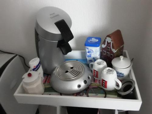 a shelf with a mixer and other kitchen items on it at Dendolili room in Amsterdam