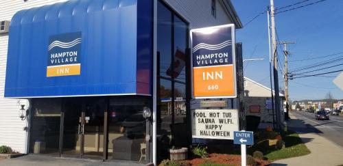 a store front with signs on the side of a building at Hampton Village Inn in Hampton