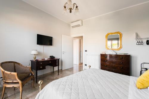 a bedroom with a bed and a desk and a mirror at Attico Panoramico - Milazzo Centro Storico - 200 mq in Milazzo