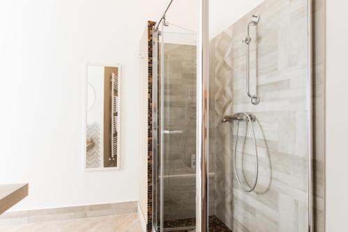 a shower with a glass door in a bathroom at Attico Panoramico - Milazzo Centro Storico - 200 mq in Milazzo