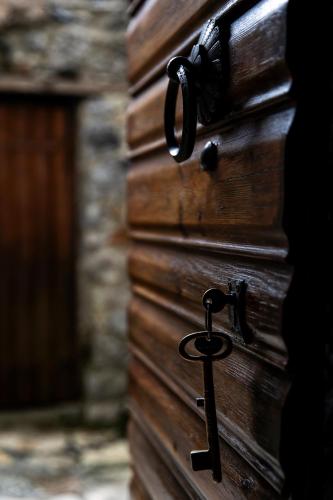 a close up of a wooden door with a key at Kanto's Guesthouse in Stemnitsa