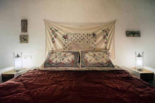 a bedroom with a large bed with two night stands at Kanto's Guesthouse in Stemnitsa