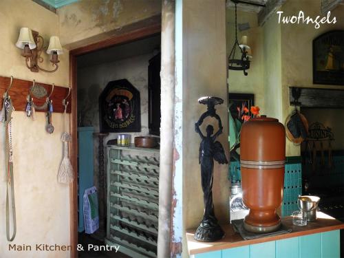 a room with a shelf with a statue of a woman at TwoAngels in Knysna