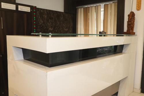 a white reception desk with a glass top at Hotel Park Residency in Vijayawāda