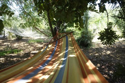 a yellow and blue hammock in a park at Egesta, villa with private pool in Calatafimi