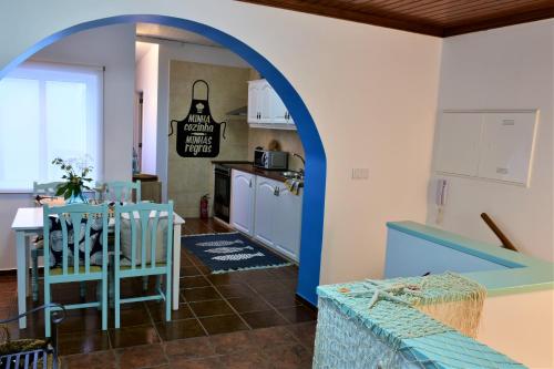a kitchen and dining room with an archway at Salty Stories in Ponta Delgada