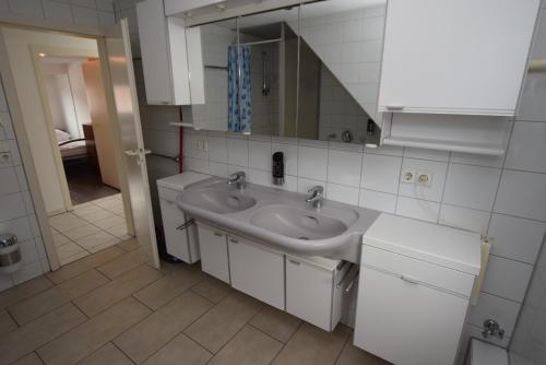 a bathroom with a sink and a mirror at Apartment Zuffenhausen in Stuttgart