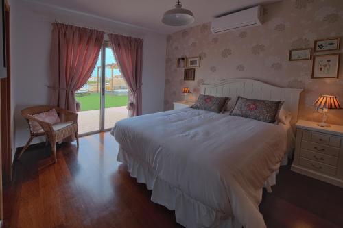 a bedroom with a large white bed and a window at Villa Aura in Costa de Antigua