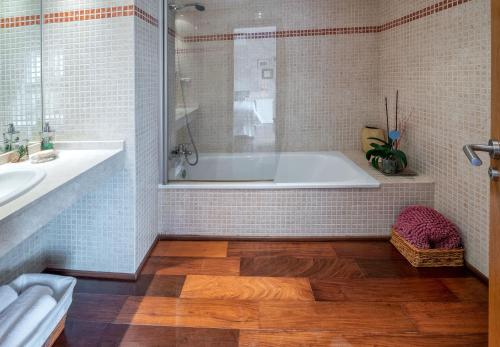 a bathroom with a tub and a sink at Villa Aura in Costa de Antigua