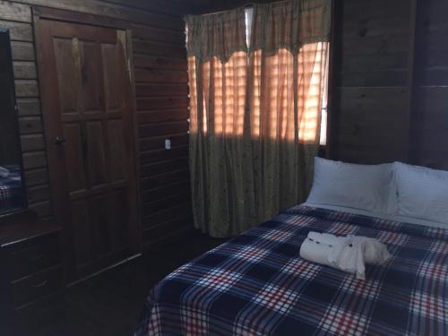 a bedroom with a bed with two animals on it at Matus Guest House in San Ignacio