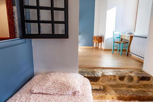 a room with a bed in the corner of a room at La Vieille Auberge in Vesc